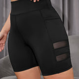 Yoga Basic Pantalones cortos deportivos de talla grande con panel de malla y bolsillo para telefono, pantalones cortos de legging