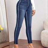 Jeans ajustados con costura lateral en contraste