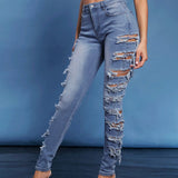 Haute Jeans Rasgados Ajustados A La Cintura Alta Con Detalle En Los Lados