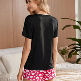 Conjunto de pijama para mujer con parte superior de manga corta con cuello redondo y estampado de letras y pantalones cortos con estampado de corazon