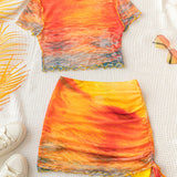 WYWH Conjunto de camiseta de manga corta y falda transparente con estampado degradado naranja y tenido de puesta de sol para mujeres de WYWH, ideal para vacaciones de verano