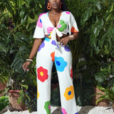 Slayr Conjunto floral de vacaciones y ocio - top corto con lazada con escote bajo y pantalones anchos elasticos, 2 piezas para mujer