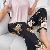 Conjunto de pijama de mujer con camiConjuntoa de manga corta de unicolor y pantalones cortos estampados de flores