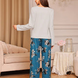 Conjunto de pijama en talla grande para mujer con blusa de manga larga de unicolor y pantalon largo estampado floral