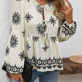 Blusa acampanada con cuello de lazo y mangas de linterna con estampado floral y volantes