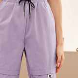Mulvari Pantalones conicos de cintura con cordon con parche de letra
