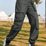 Pantalones cargo calle cintura V con estampado de camuflaje con diseno de cremallera con parche con bolsillo con solapa persona que practica jogging